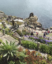 A stone theatre built into the cliff by the sea