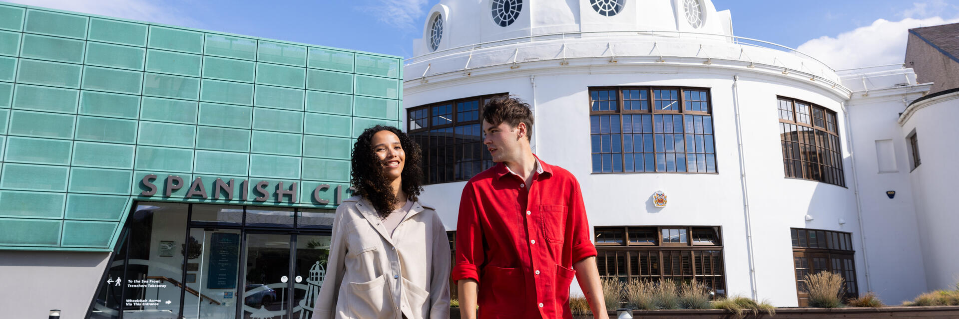 Two friends visiting an old art deco seaside building.