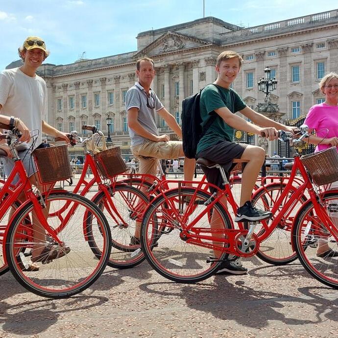 Group of people on bicycles on an Old London Tour in front of Buckingham Palace