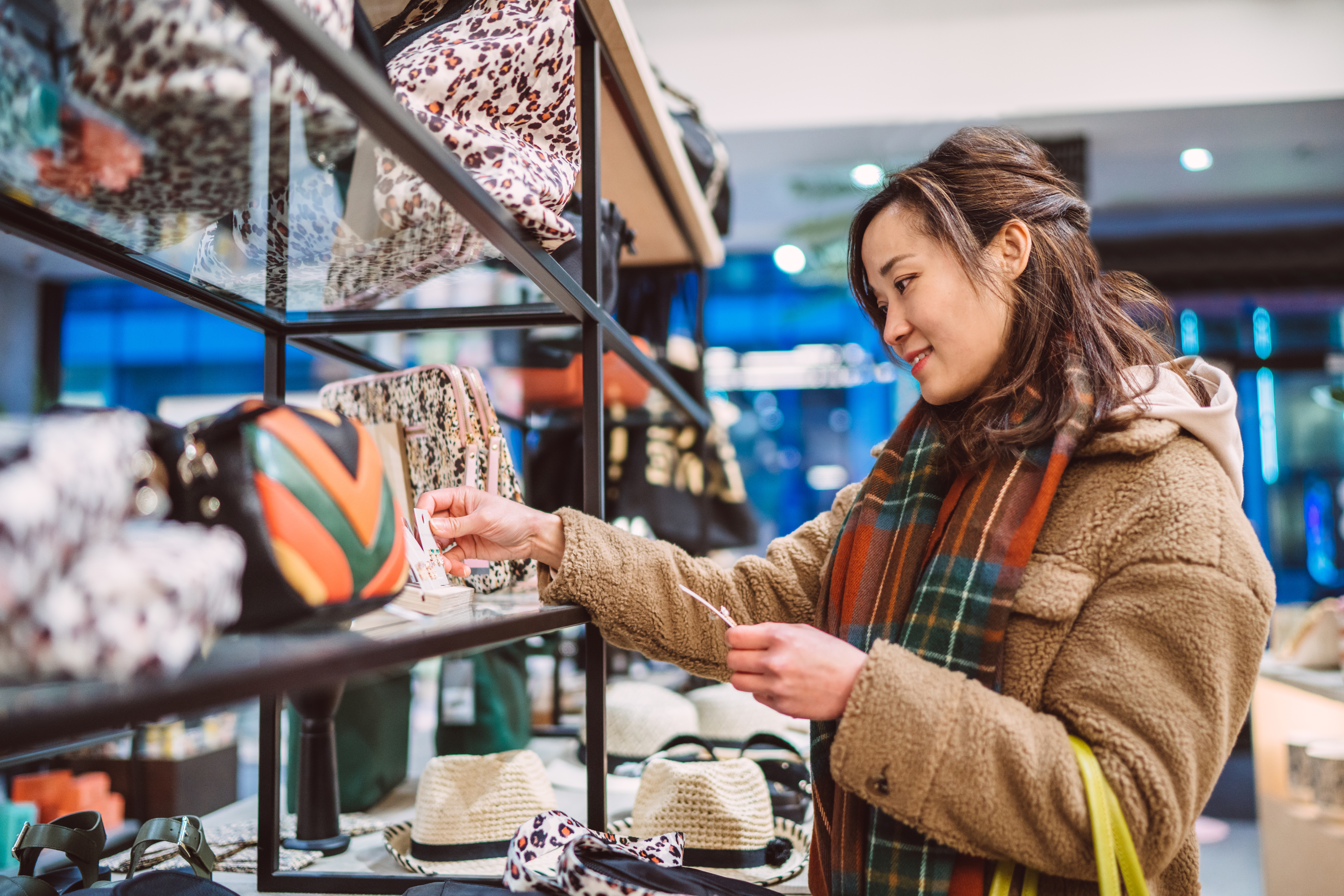 A woman shopping for accessories in boutique.