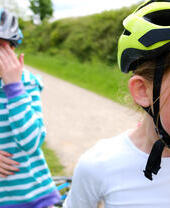 Two girls cycling on the Tissington and High Peak trail in the Peak District, UK.