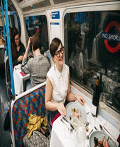 A group of people dining on the Supper Club Tube, a gourmet restaurant built into an underground tube train