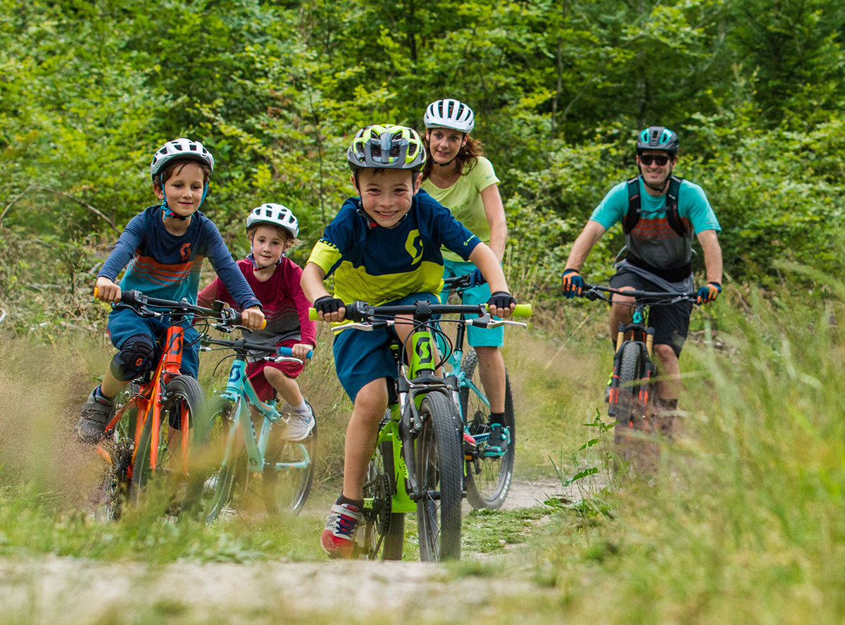 A group of children and parents cycling through the Leicestershire countryside