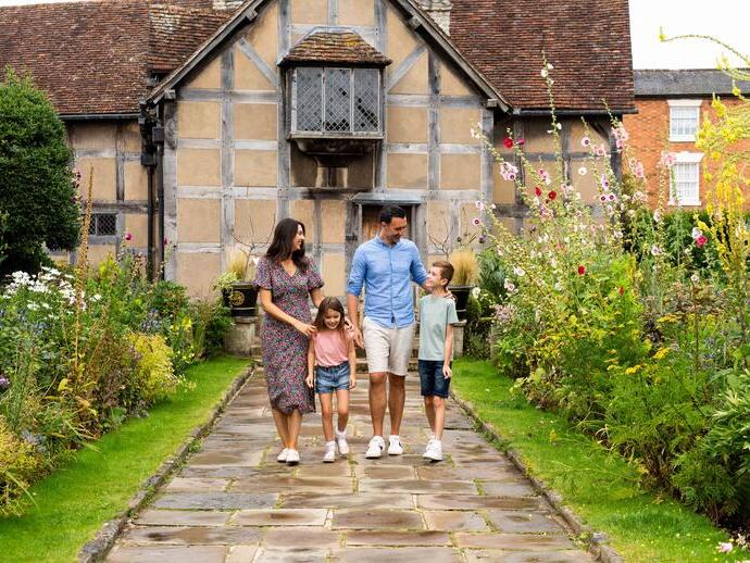 A family walking together outside heritage building