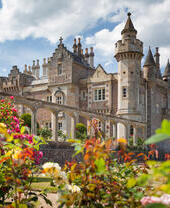 Abbotsford exterior with flower gardens in foreground