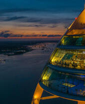 Night time view of a modern restaurant inside a tower