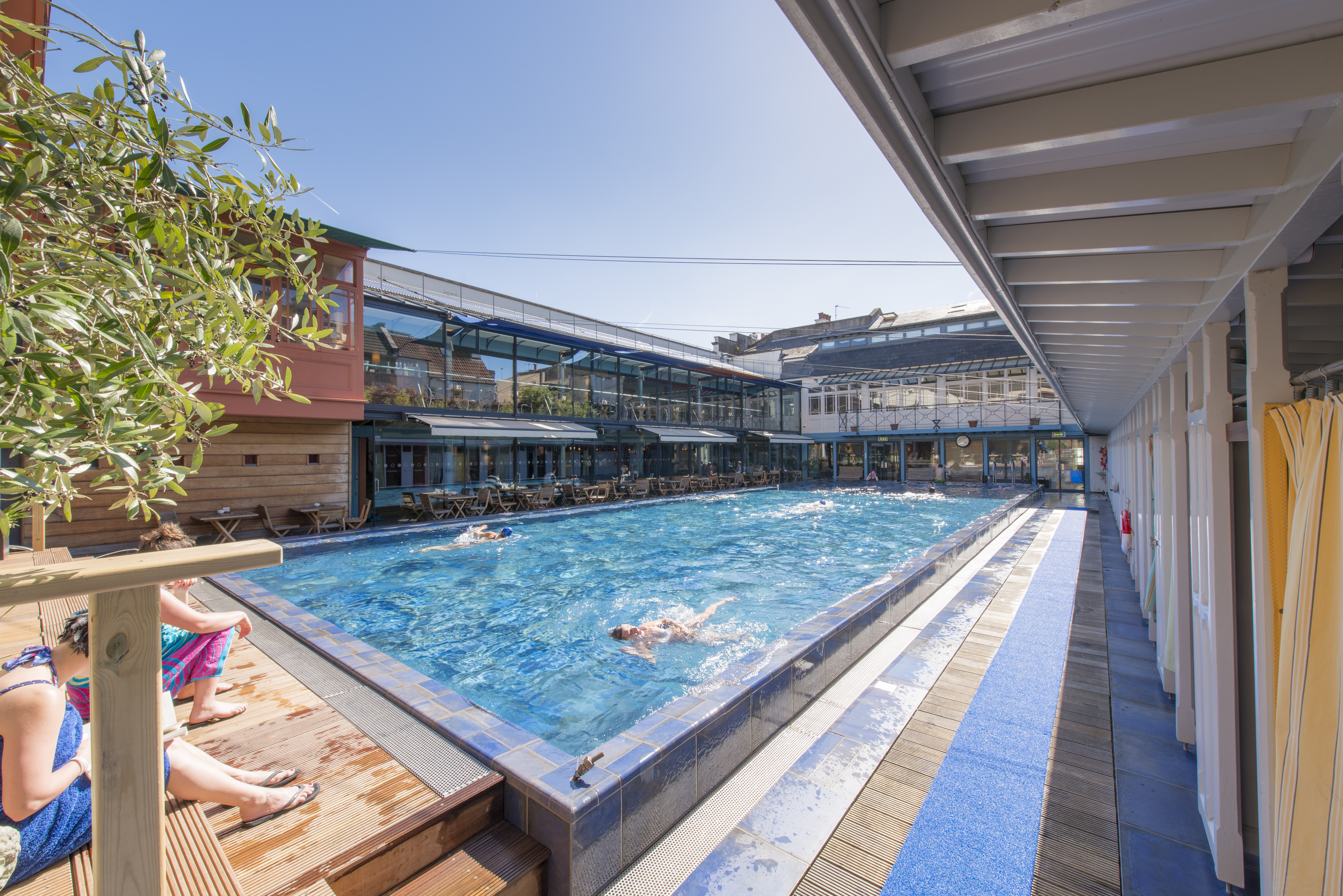 People swimming in an outdoor pool at Bristol Lido