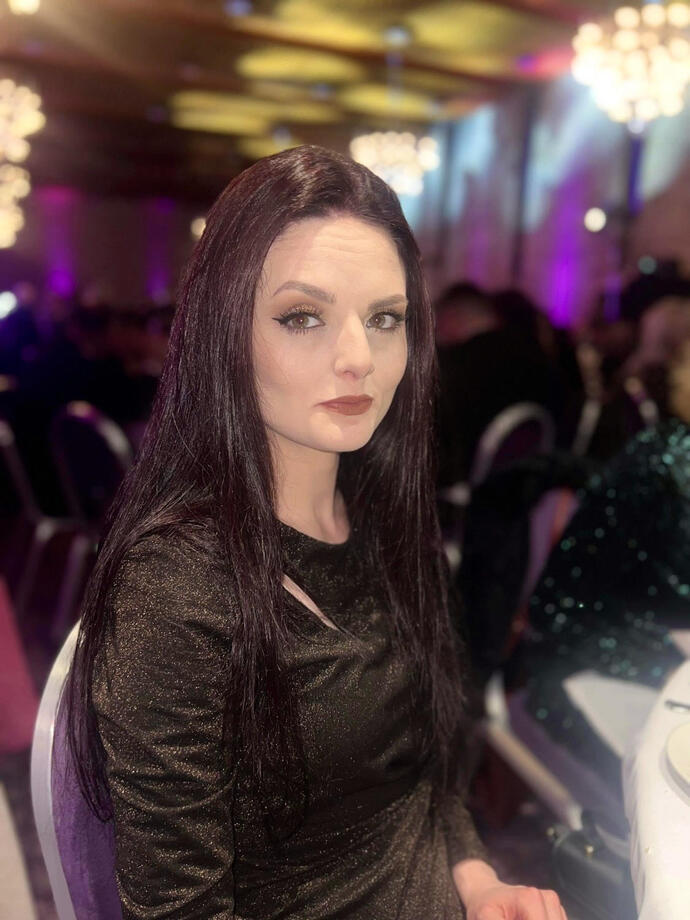 A woman taking part in an escape room challenge.