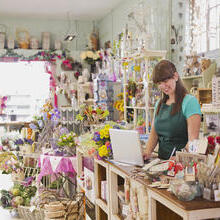 Woman using a laptop in a gift shop