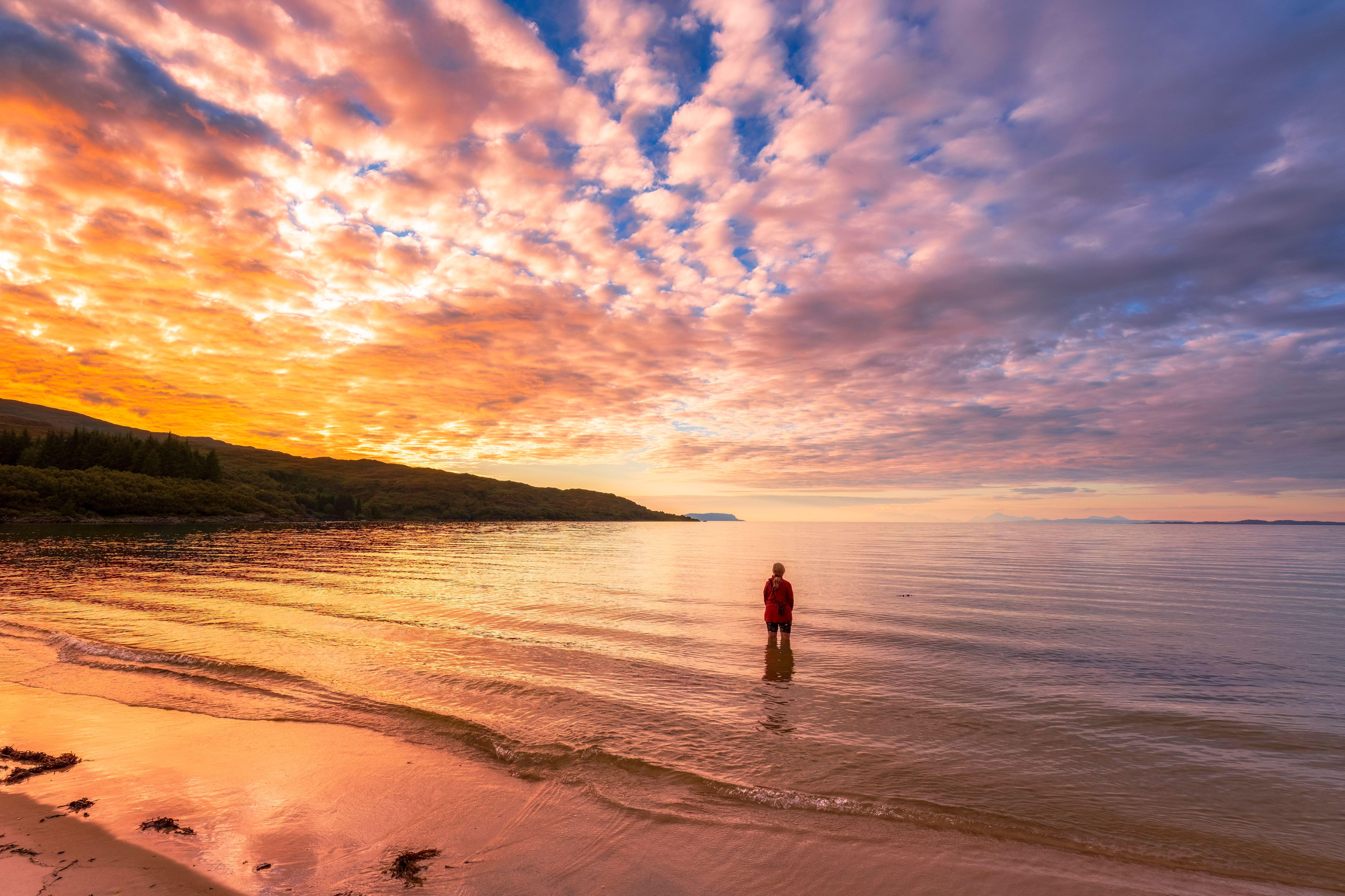 Woman standing in water at Singing Sands beach