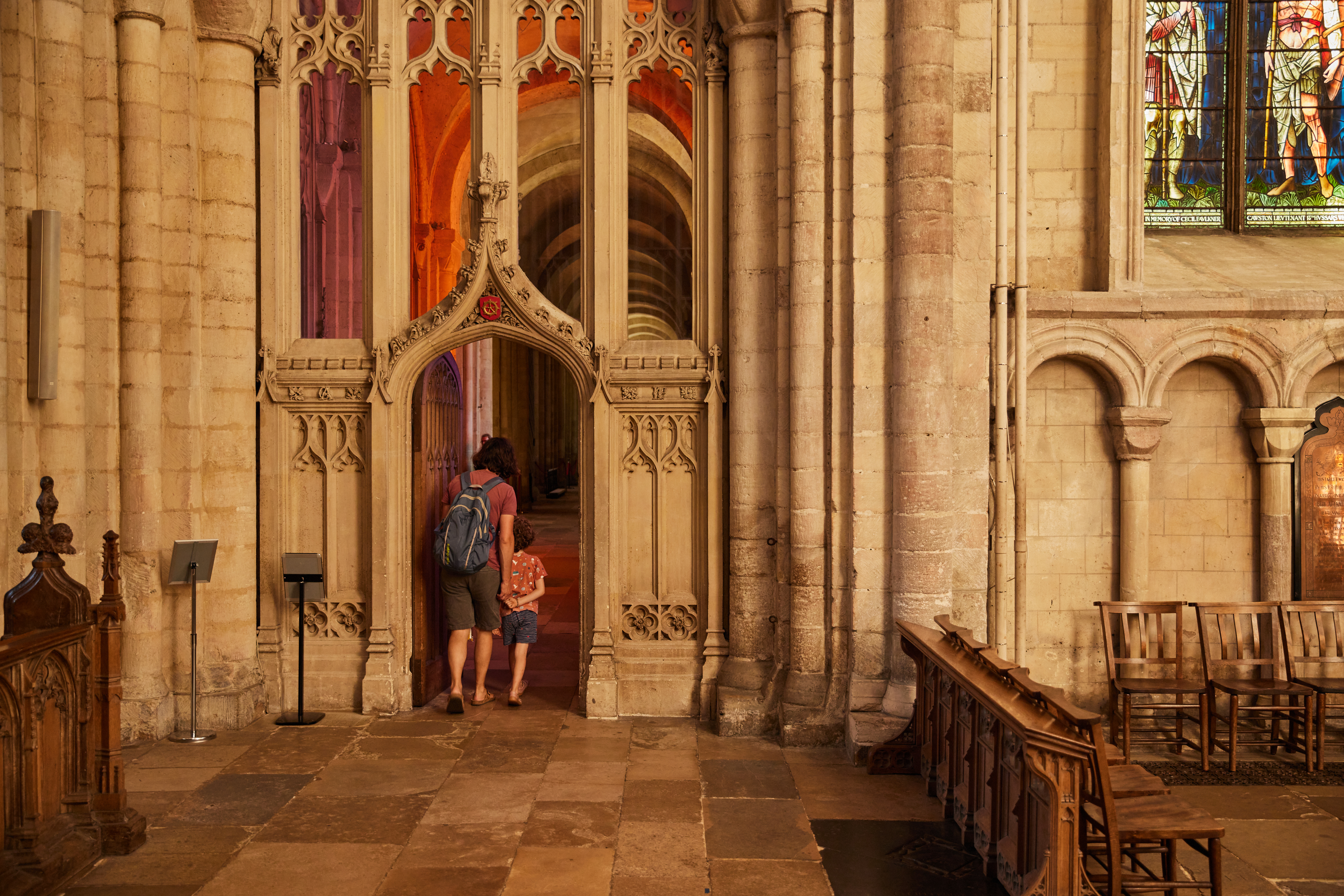 A woman and child exploring the interior of Norwich Cathedral