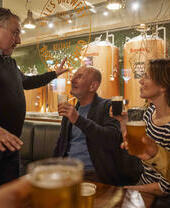 A tour guide taking a group through Bell's Brewery in Belfast