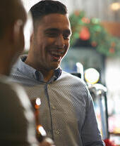 A group of people drinking at a bar