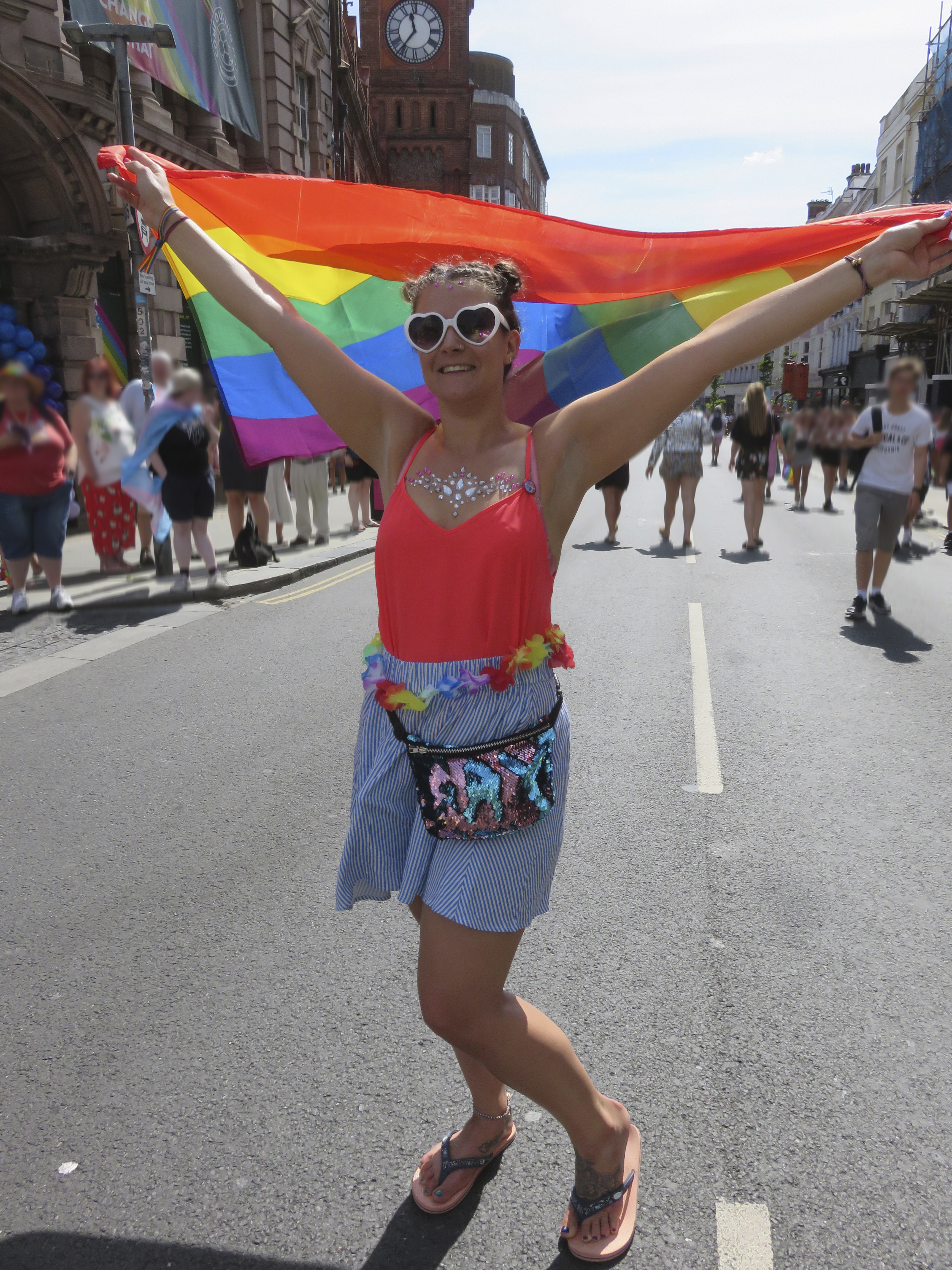 Woman flying rainbow flag during Pride