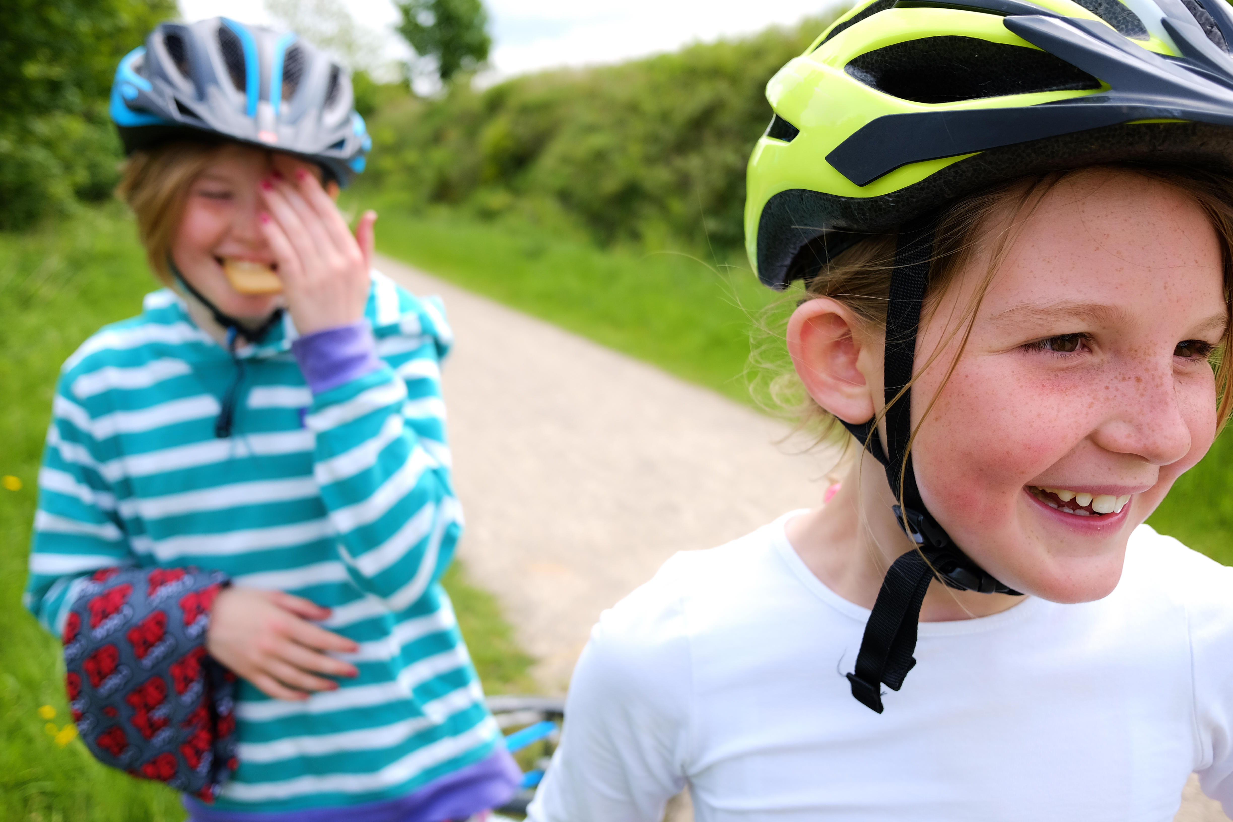 Two girls cycling on the Tissington and High Peak trail in the Peak District, UK.