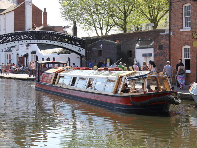 A barge sailing down a canal in Birmingham, near Sherborne Wharf