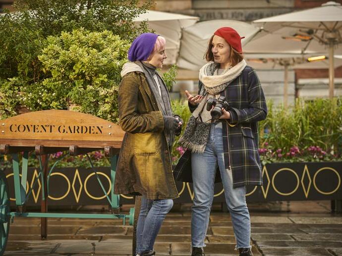 Two women talking in a piazza