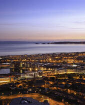 An overhead shot of Swansea town and seaside at dusk.