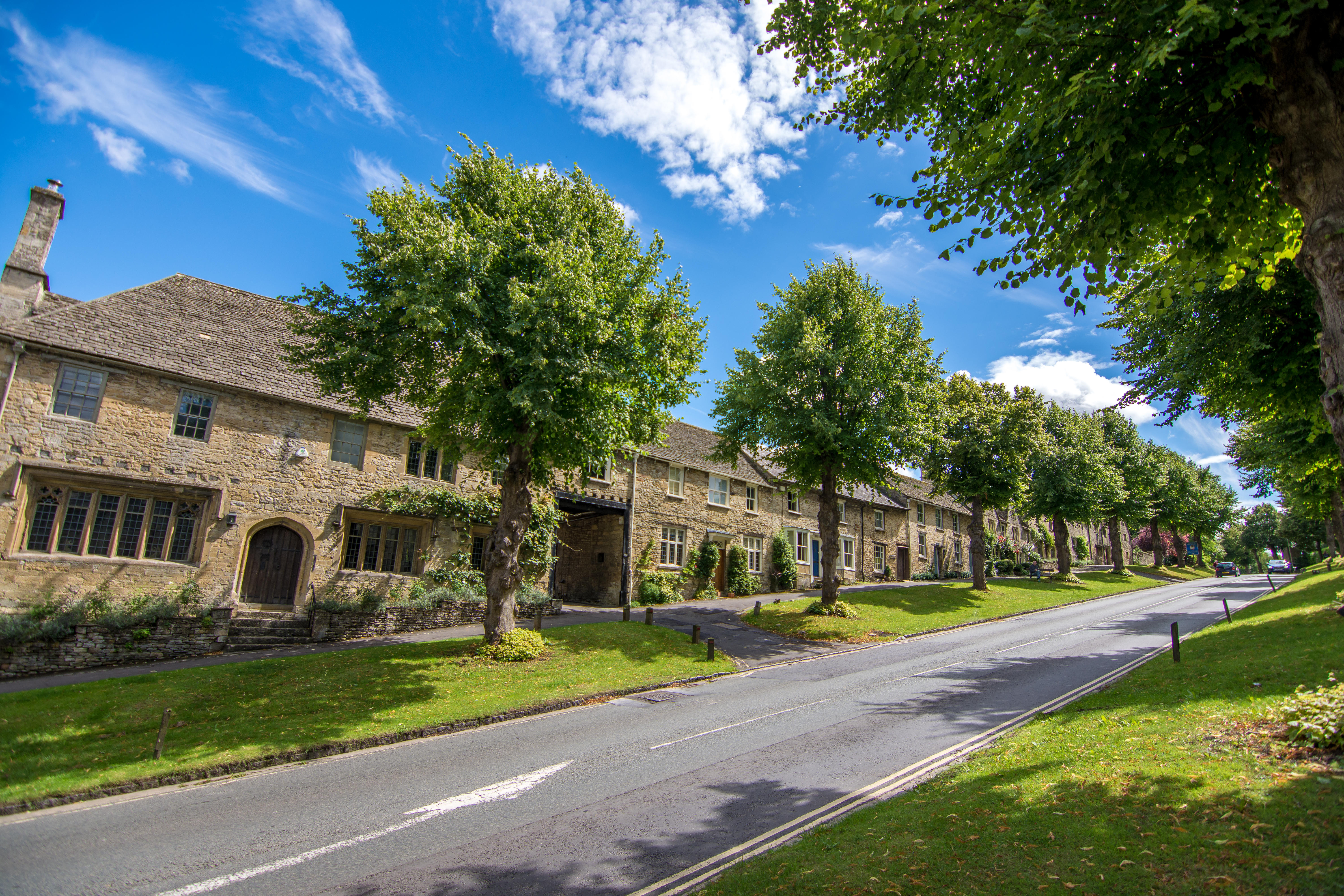 A tree lined street in Burford village