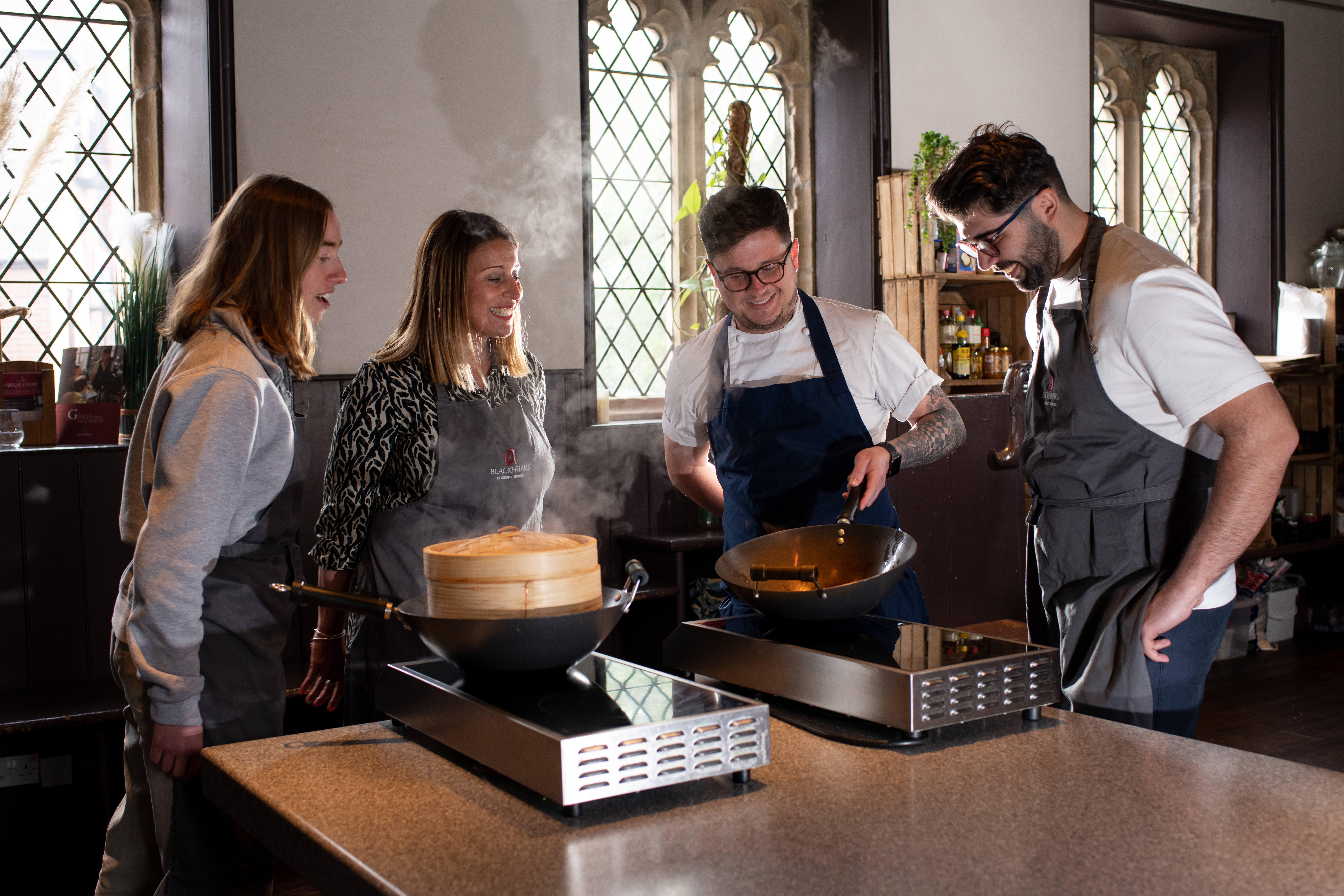 A group of people watch a cooking demonstration