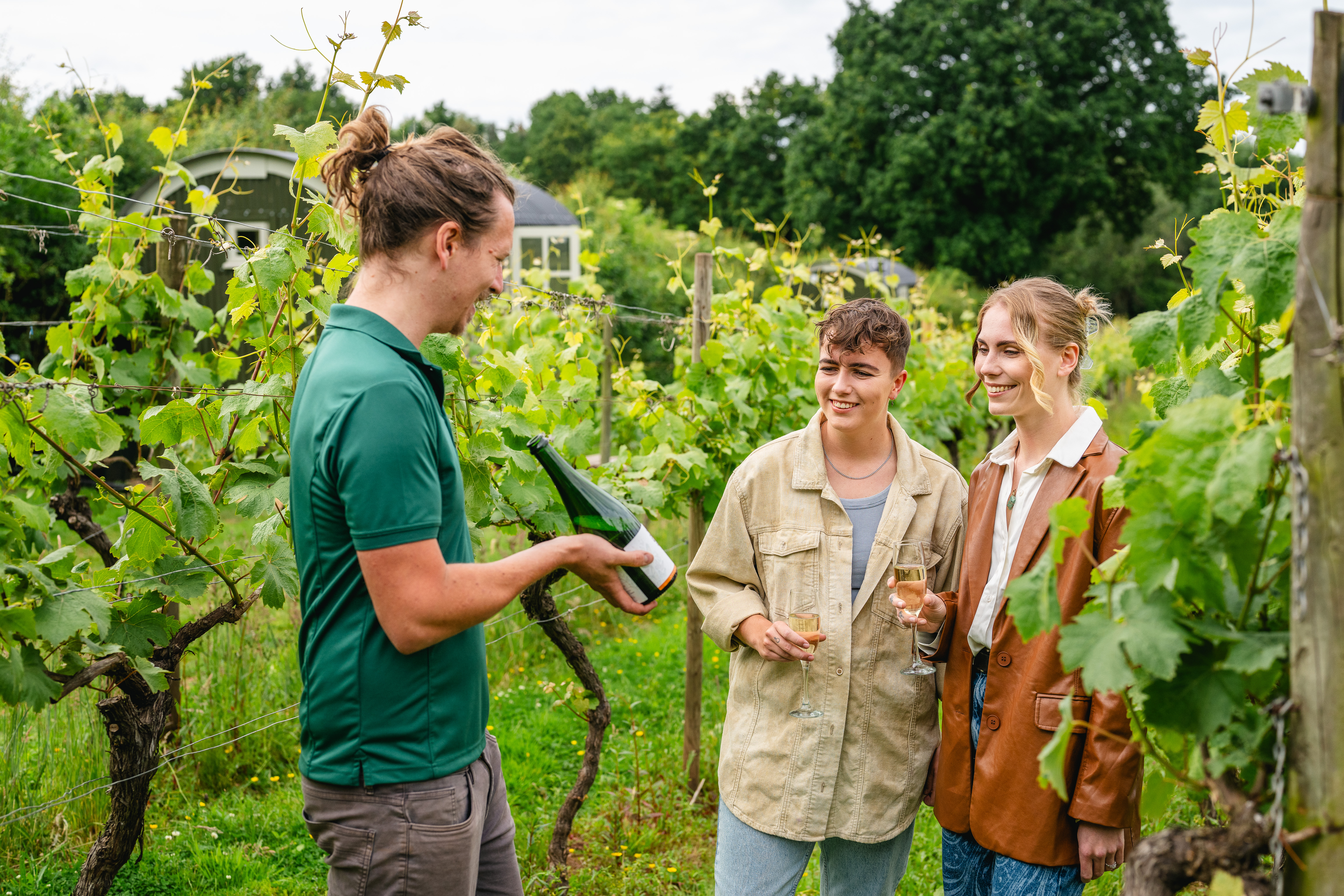 Two women enjoying a guided Vineyard tour and wine tasting experience