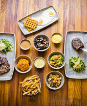 Two people eating steaks at Liverpool's Cowshed Restaurant