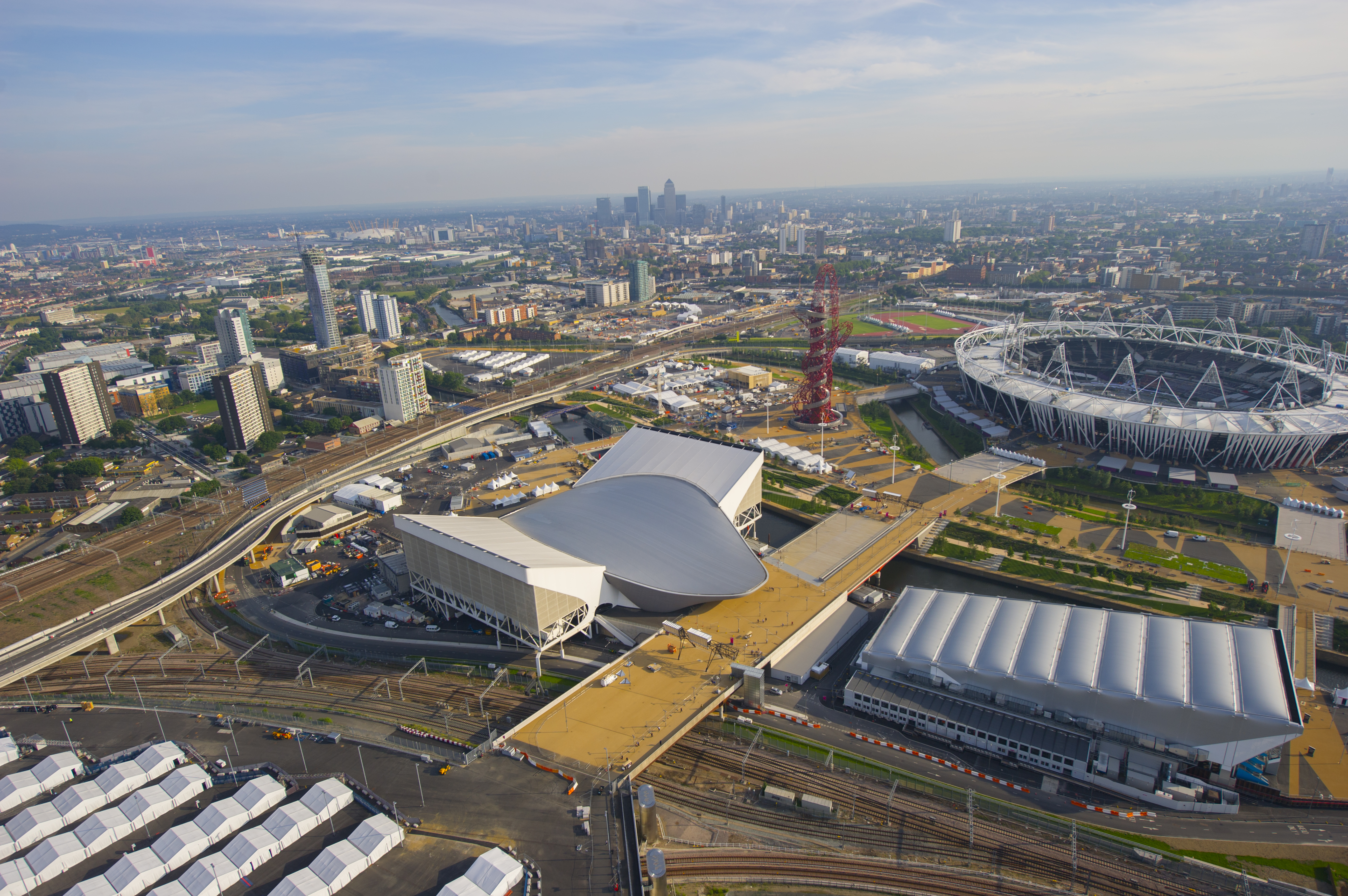 Aerial view of a city with stadium and modern buildings