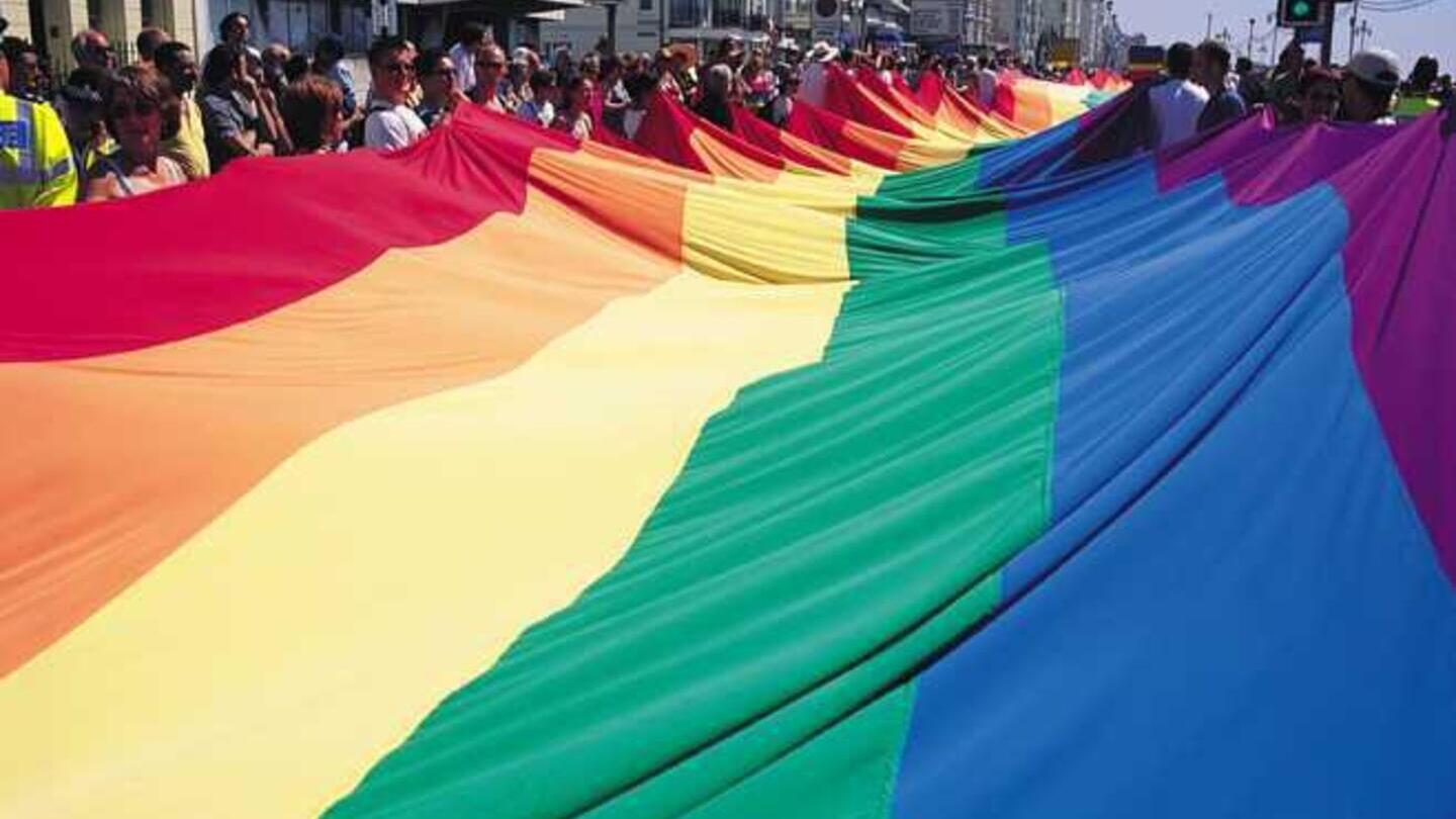 Large Pride Flag being waved in Brighton