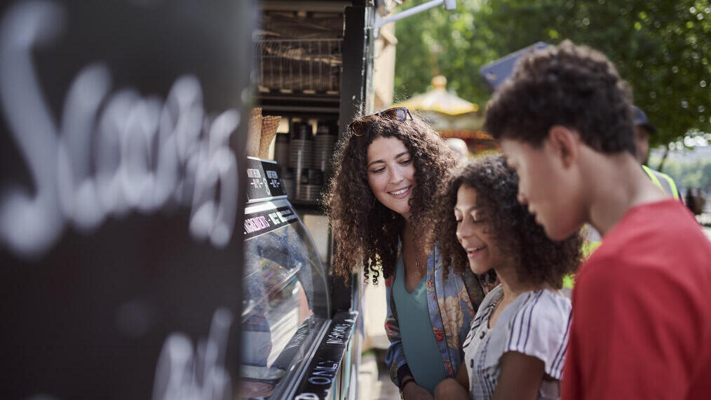 Friends buying ice-cream at the stall