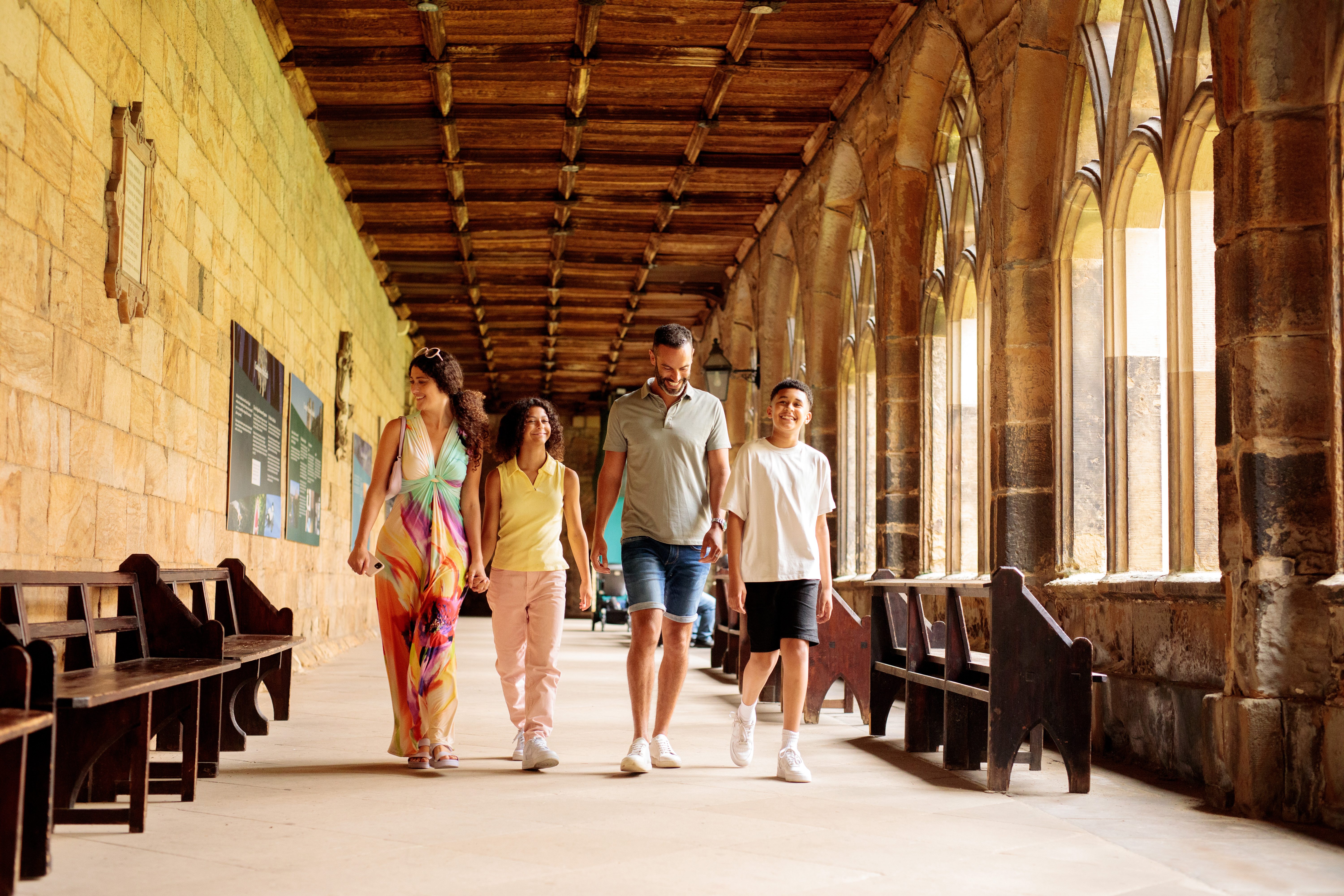 Family walking through the cloisters of a cathedral
