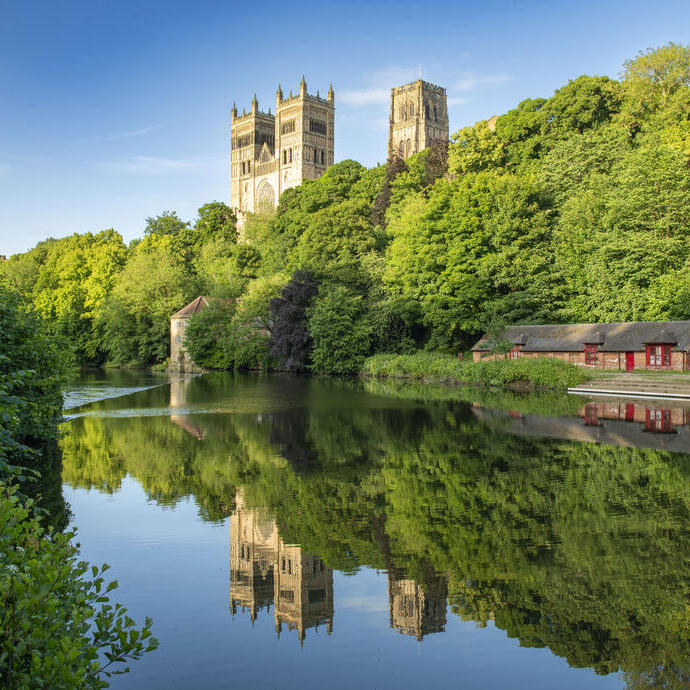 A view of a river with a Cathedral beyond.
