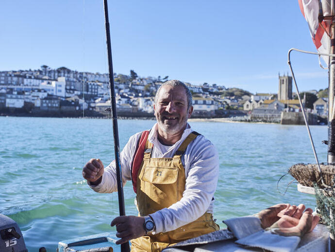 Fisherman in a fishing boat in the sea