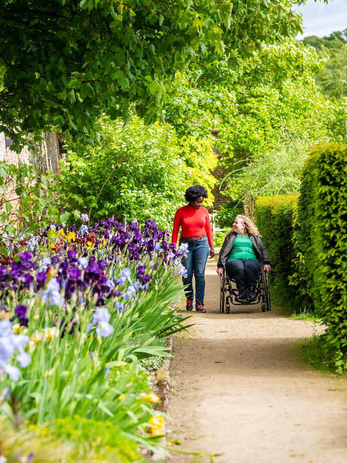 Two women in a Walled Garden, one using a wheelchair