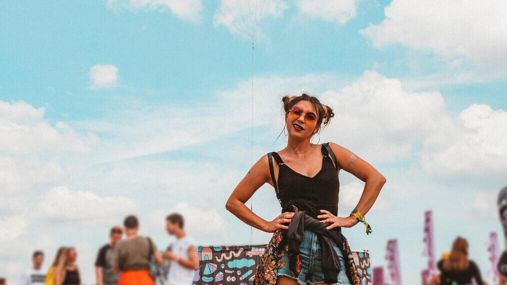 Woman standing with her hands on her hips at a music festival