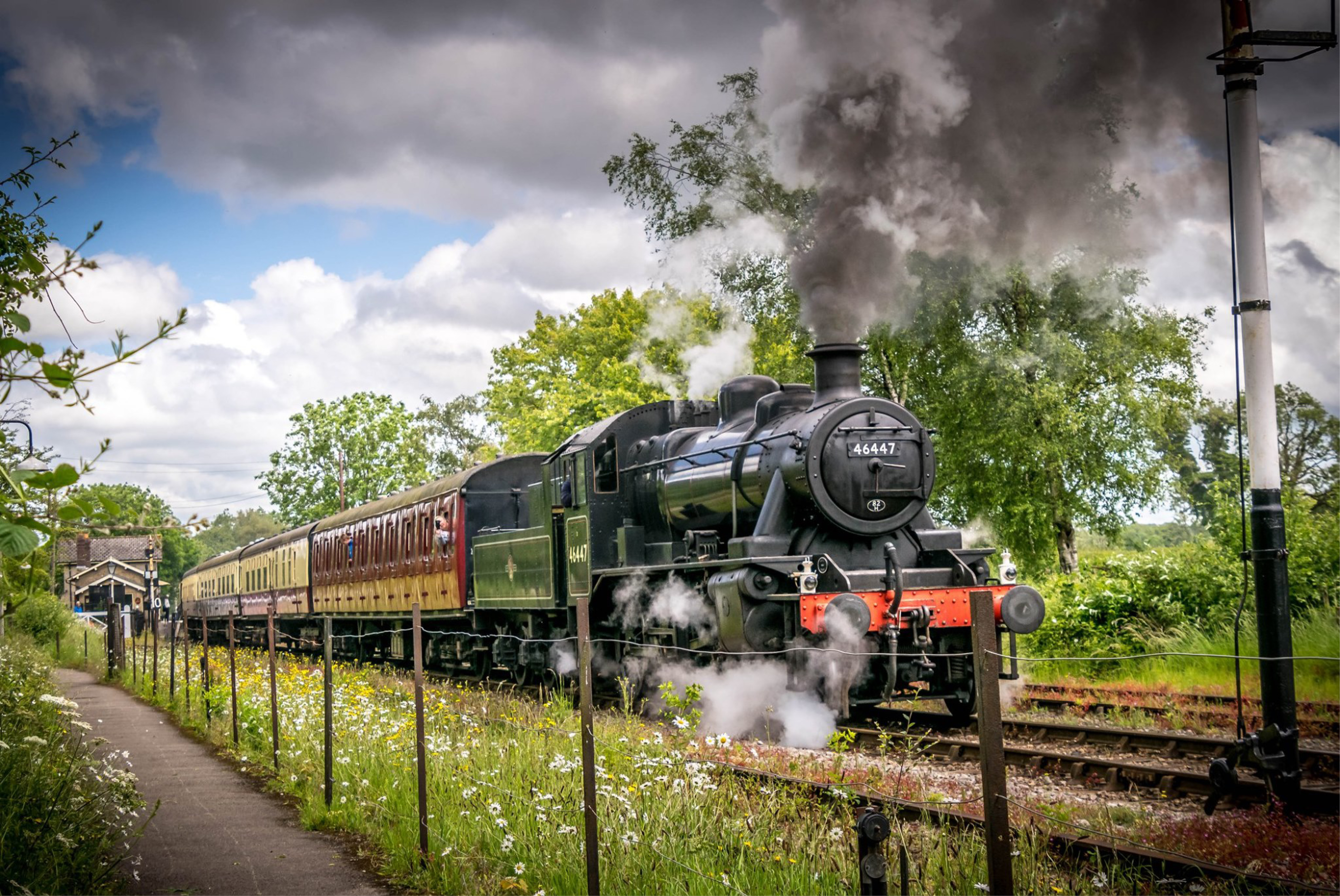 A steam train moving down a track
