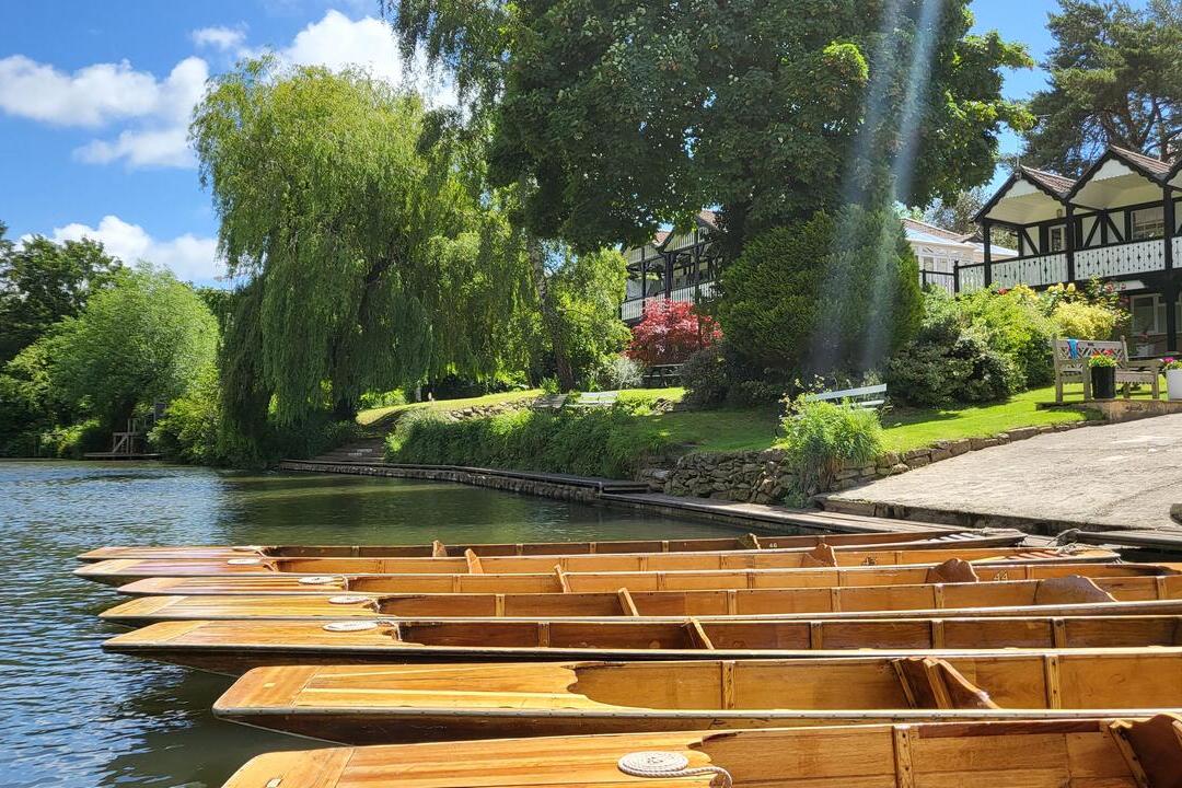 Rows of kayaks lined up on the shore at Bath Boating Station