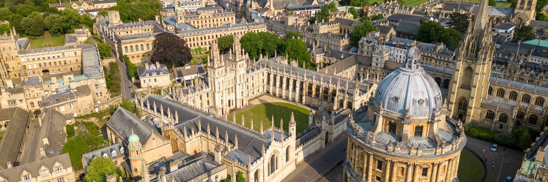 Aerial view of university featuring large dome and historic stone buildings 