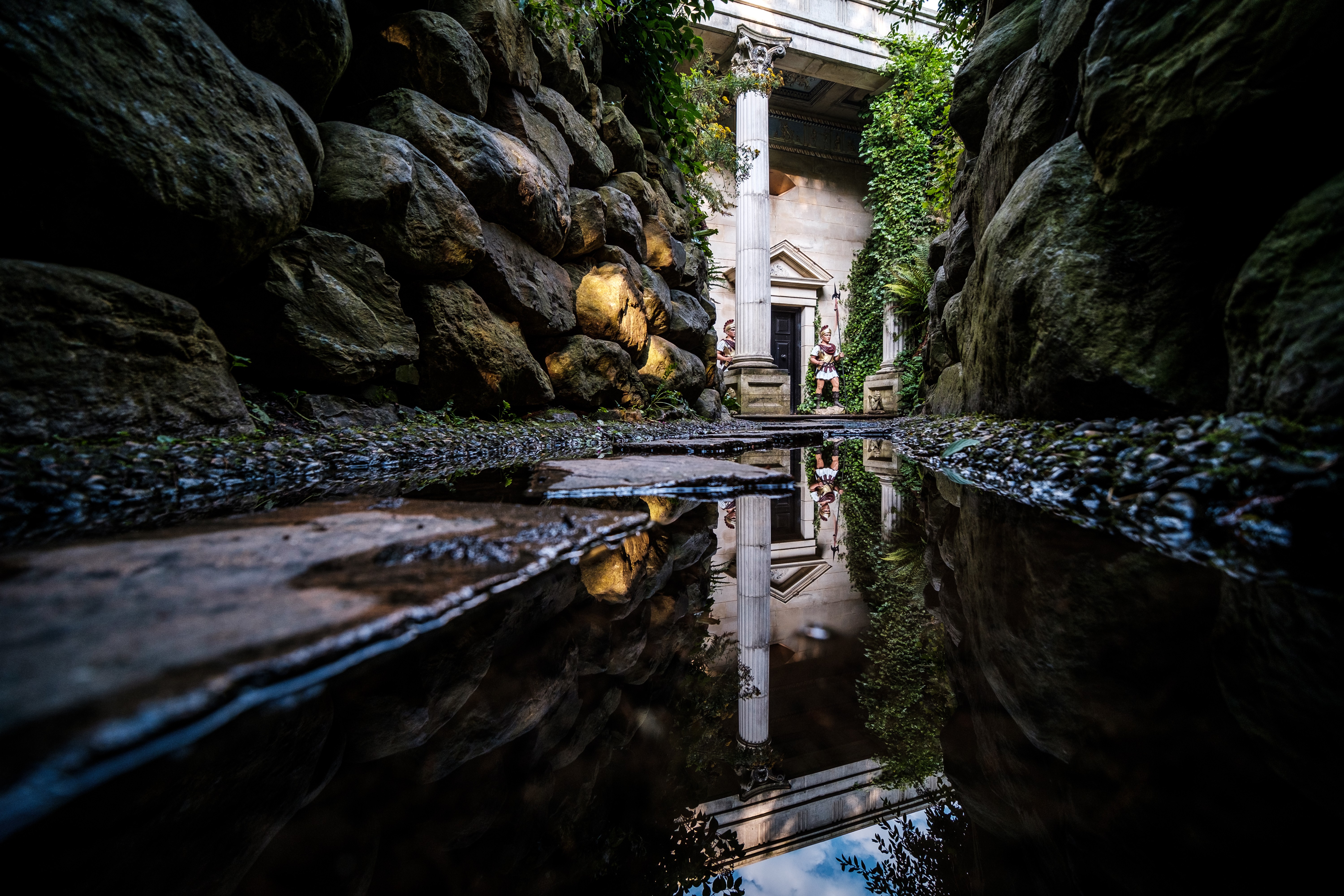 Statues of Roman Soldiers flanking an entrance in the Forbidden Corner labyrinth attraction in Yorkshire