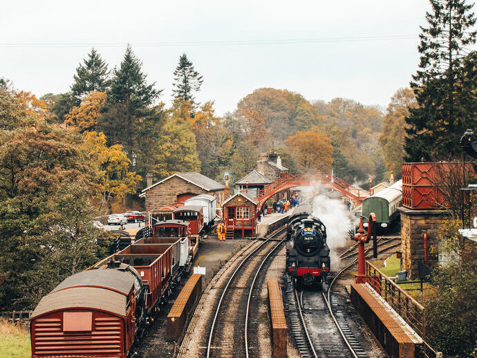 Steam train leaving a train station