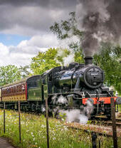 A steam train moving down a track
