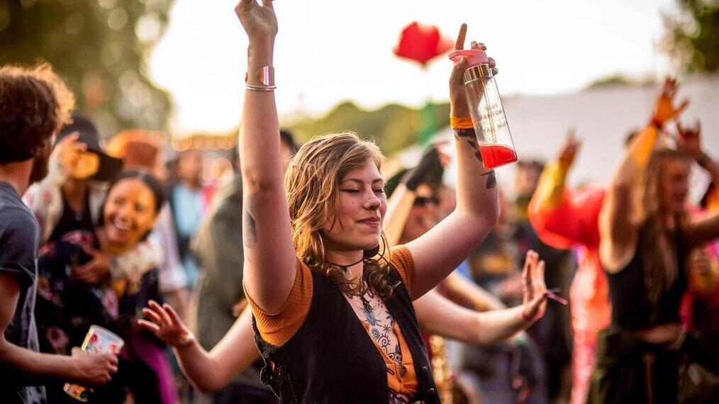 A lady dancing in the foreground at Eden Festival