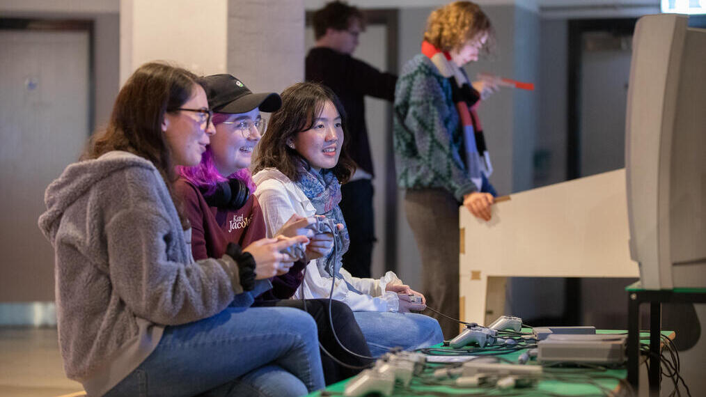 A group of people playing a video game together at the National Video Games Museum in Sheffield