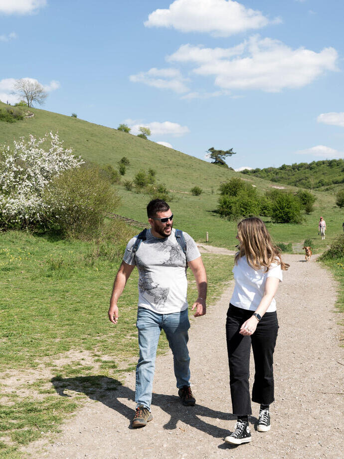 A man and woman walking along the National Trust Black Down