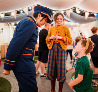 Character actors talking to a young child.