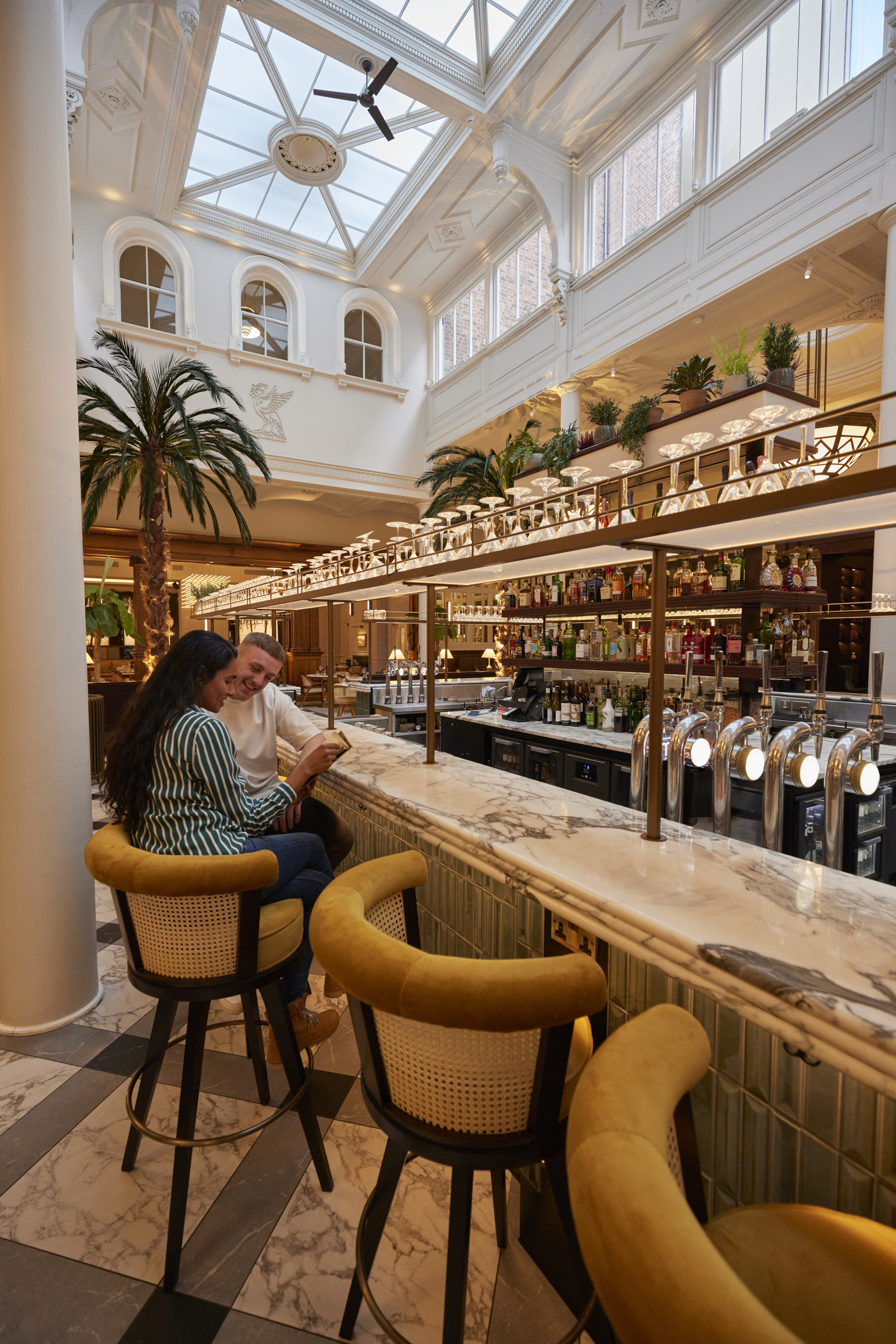 Two people order a drink at the city luxury hotel bar.