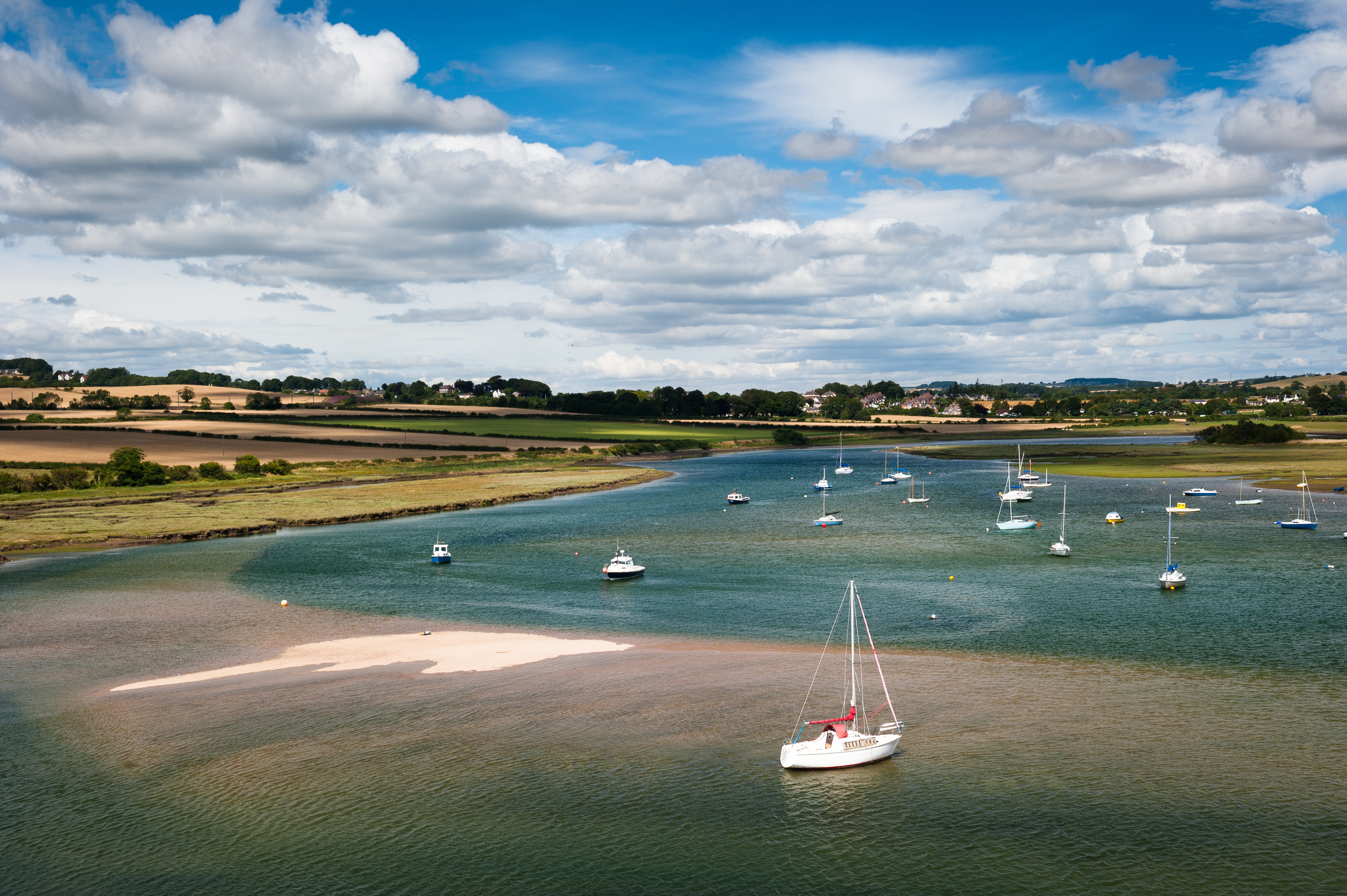 Sailboats moored on the a river at the edge of the North Sea