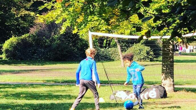 Two boy playing football
