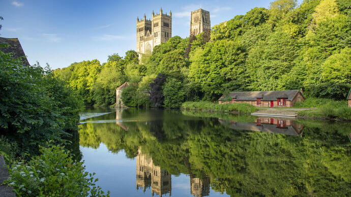 A view of a river with a Cathedral beyond.