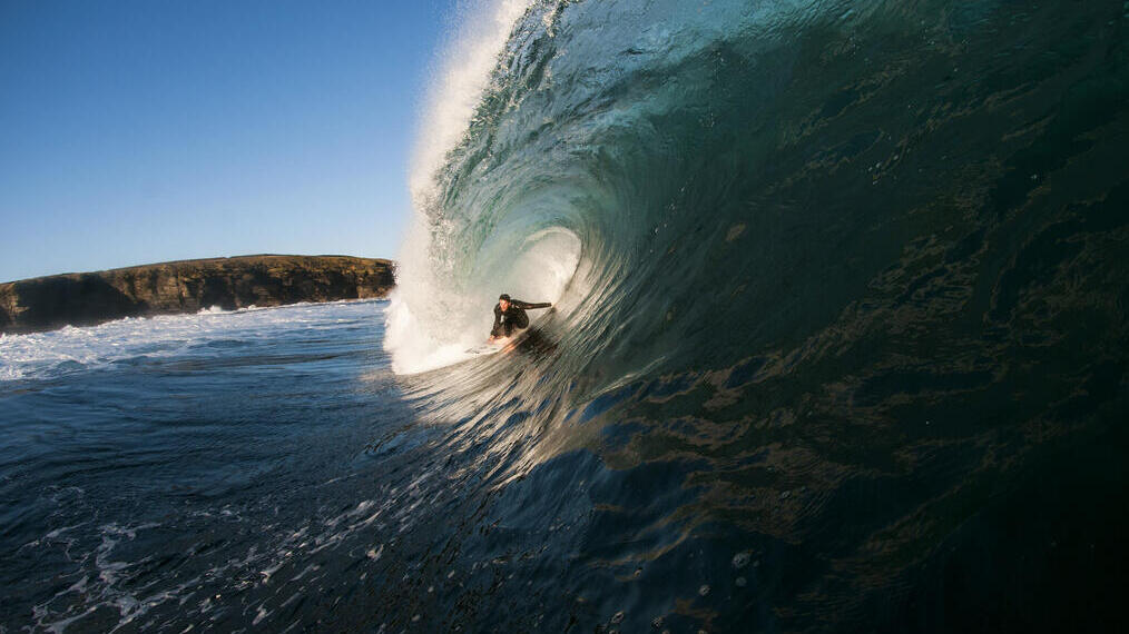 رجل يتزلج على موجة ضخمة في البحر