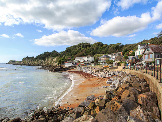 Coastline with sand and houses in a cove